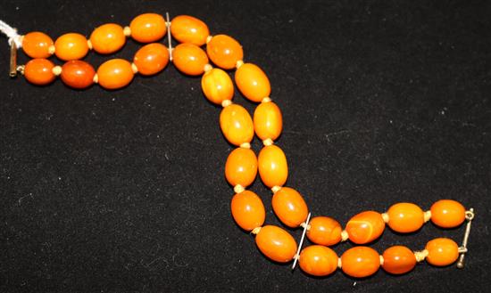 A single strand oval amber bead necklace with spacers, 15.5in.